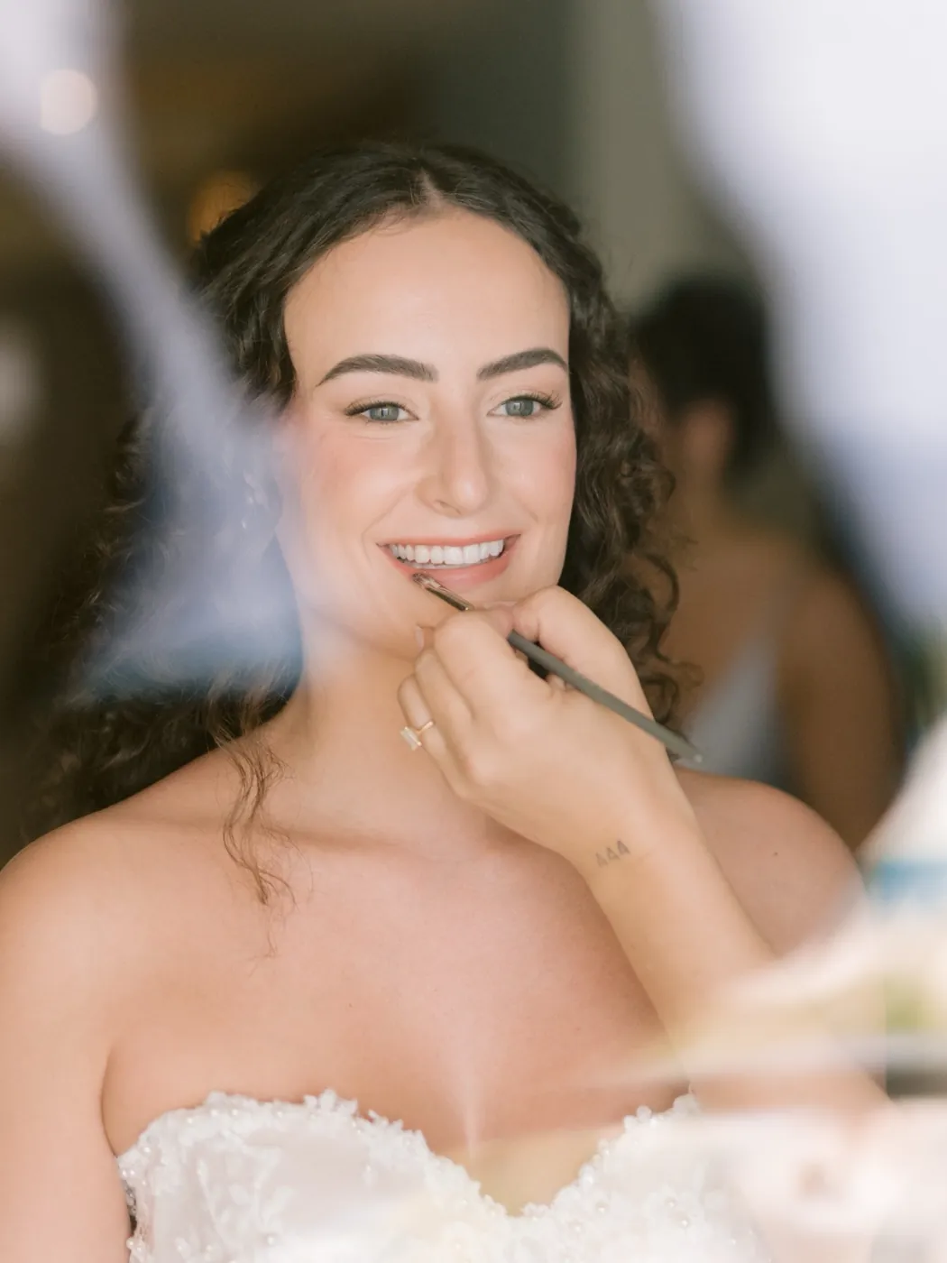 Bride smiling as her lip is finished with a brush, Hyatt Ziva Cancún