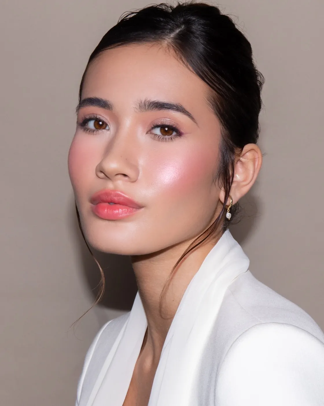 Cherry lips and flushed cheeks on glowing skin, white lapel
