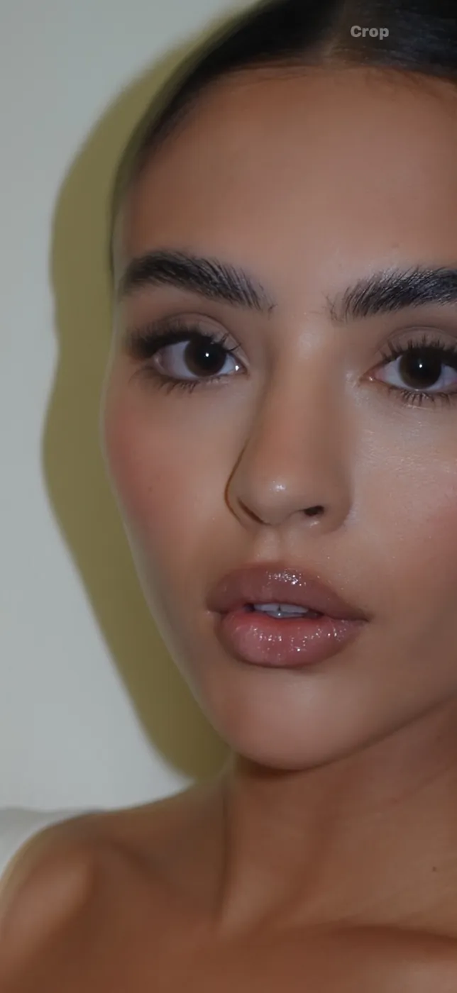 Close-up of sculpted brows and a glossy nude lip
